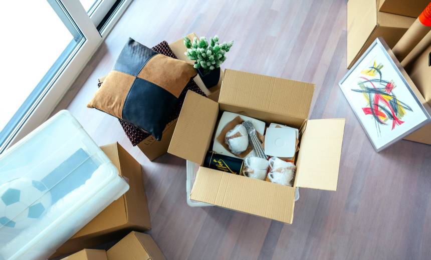 living room with stack of moving boxes utc resize