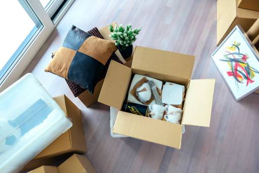 living room with stack of moving boxes utc resize