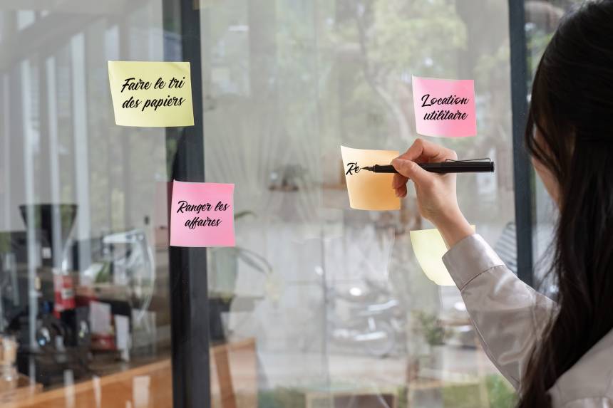 close up hand businesswoman writing sticky notes utcr